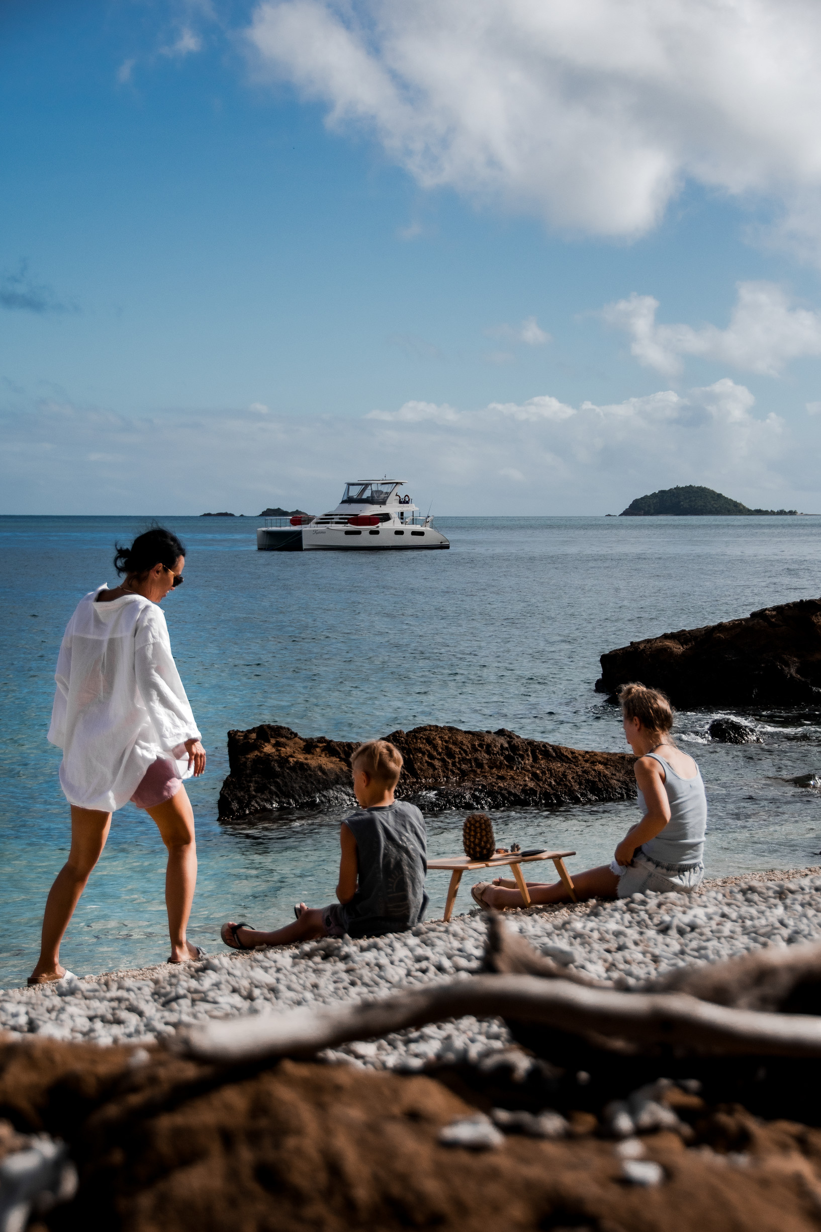Family sitting on a coral beach, sailing Whitsunday Islands | Guide Whitsundays family holiday Family sitting on a coral beach, sailing Whitsunday Islands | Guide Whitsundays family holiday