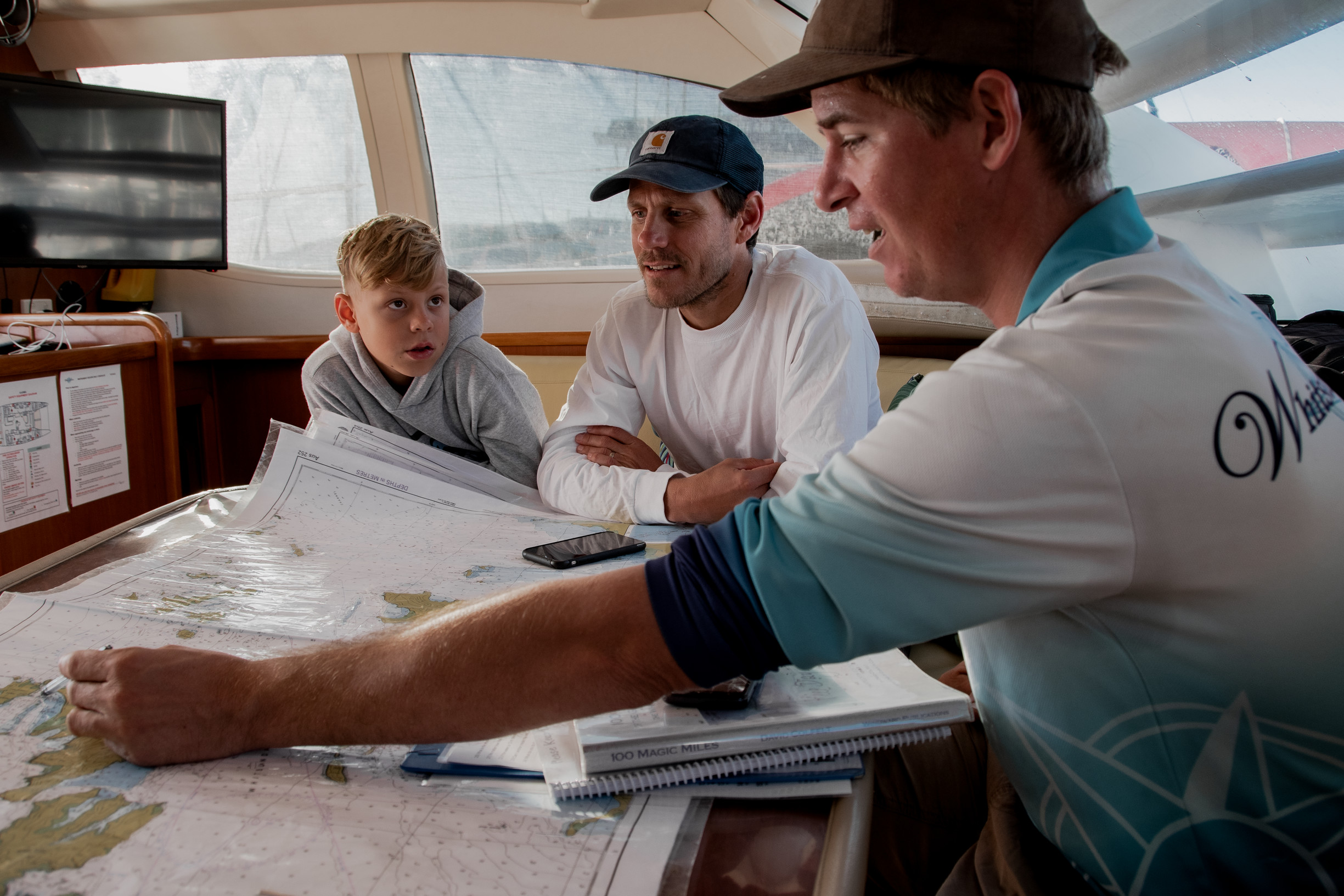 Skipper with family on board a boat charter with Whitsunday Escape | family sailing holiday whitsundays Skipper with family on board a boat charter with Whitsunday Escape | family sailing holiday whitsundays