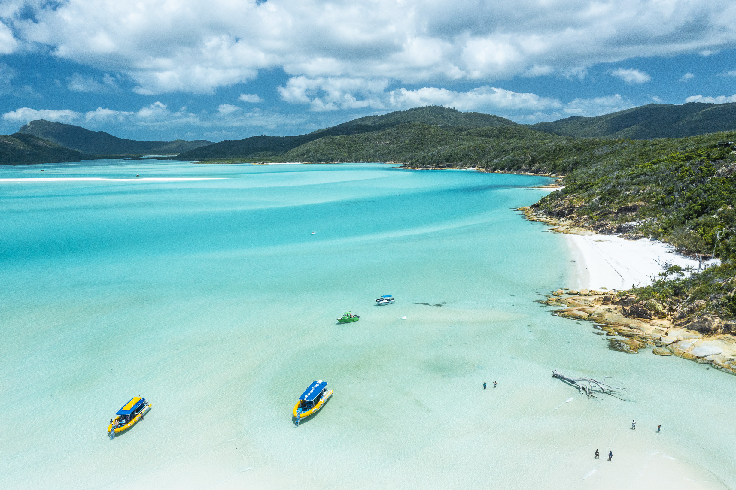 Aerial view of boats moored off beautiful white sand beach