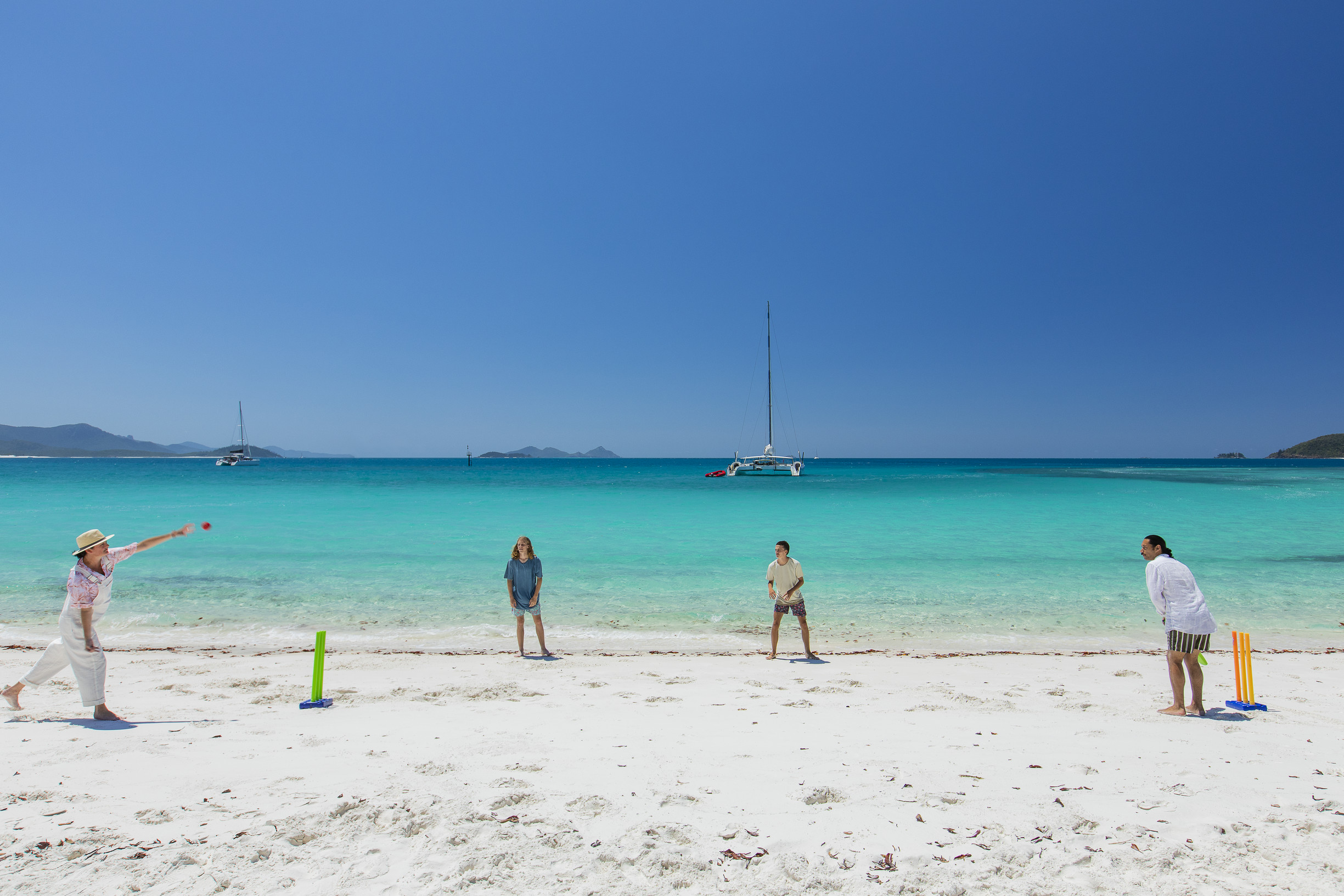 Guests playing beach cricket on Whitehaven Beach during a tour with Explore Group | Christmas in Queensland Guests playing beach cricket on Whitehaven Beach during a tour with Explore Group | Christmas in Queensland