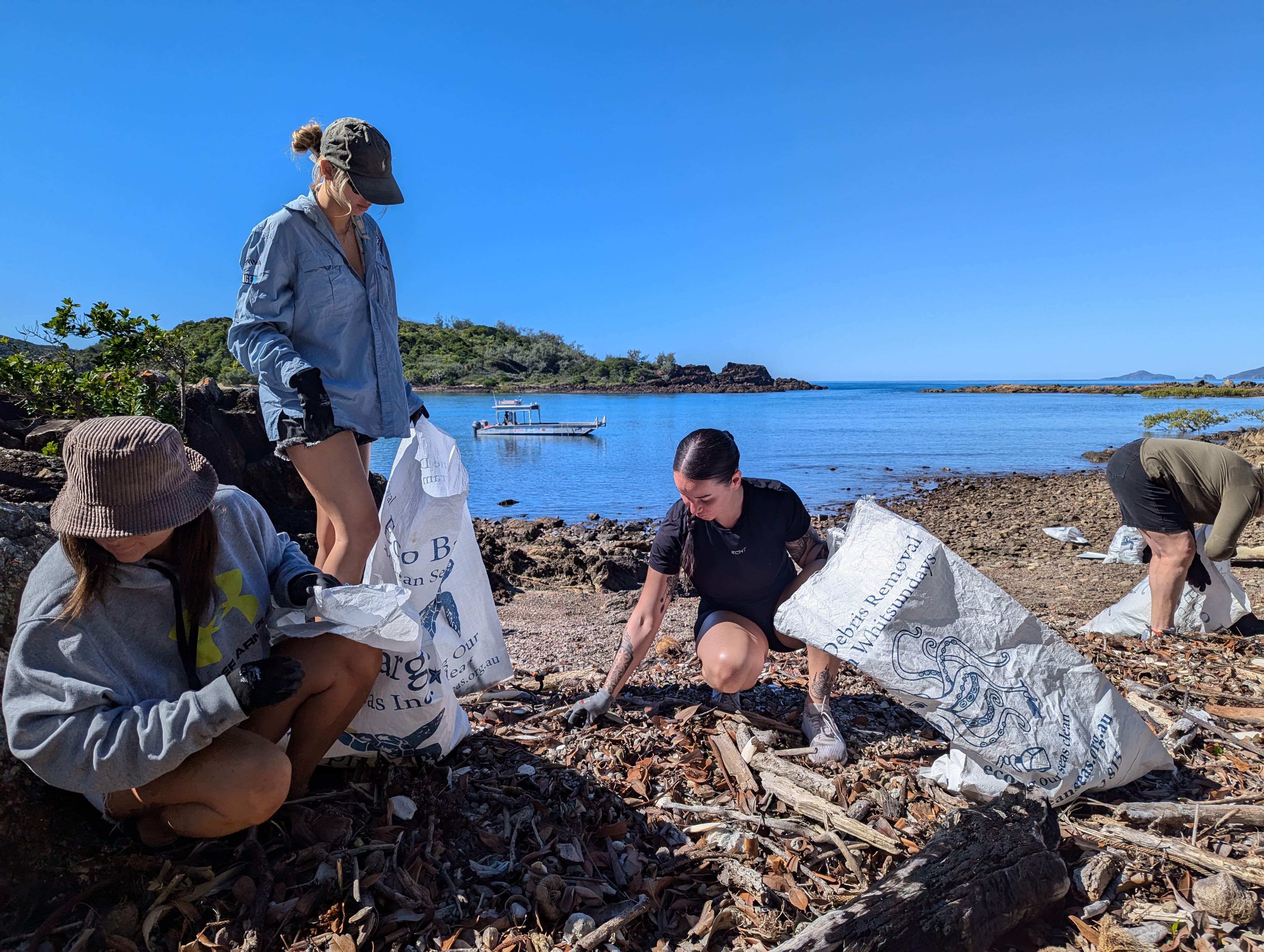 People cleaning up rubbish on the beach.