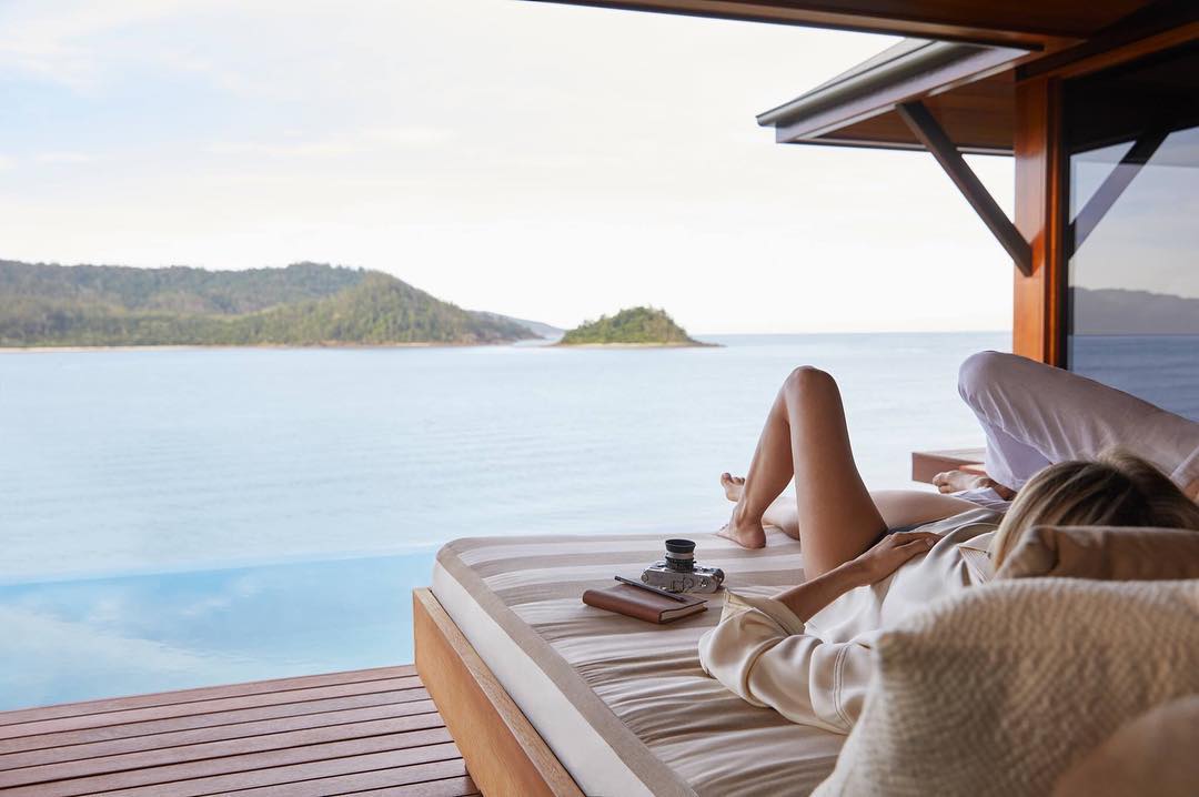 Couple relaxing on sun loungers at Qualia resort