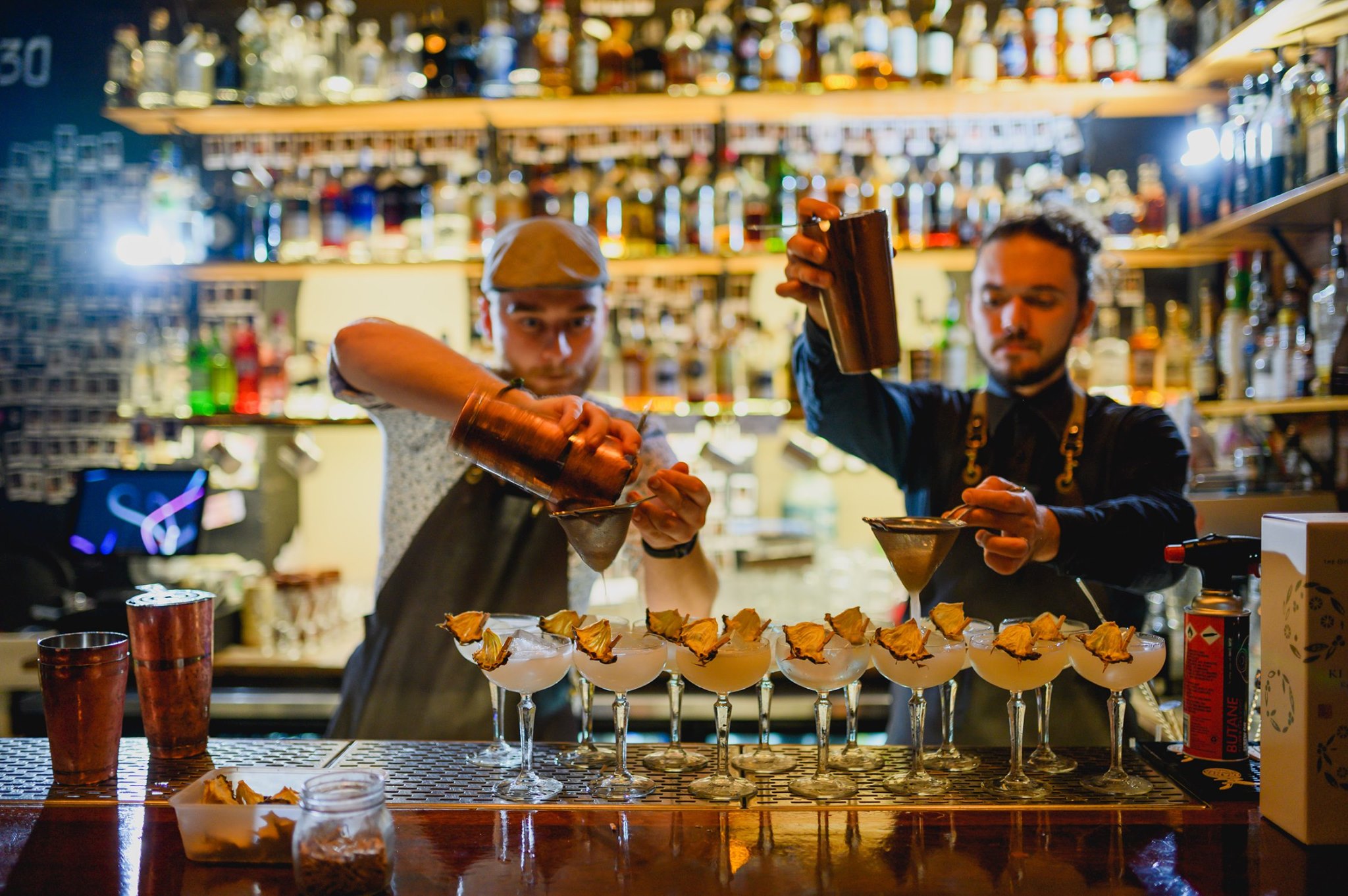 Bartenders pouring cocktails at Hooch and Fellow, a Townsville cocktail bar Bartenders pouring cocktails at Hooch and Fellow, a Townsville cocktail bar
