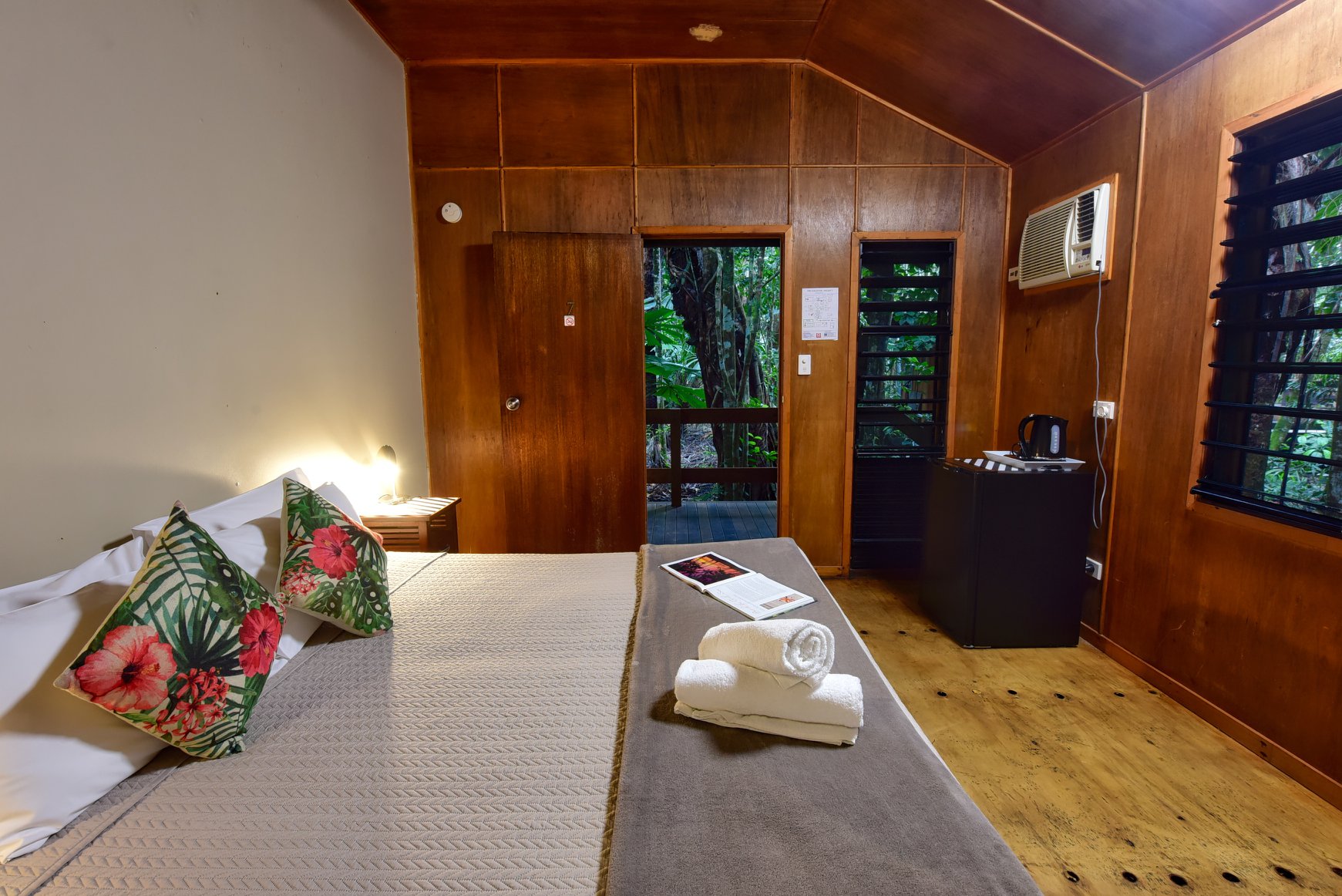 Inside view of an accommodation room including bed and open door Inside view of an accommodation room including bed and open door