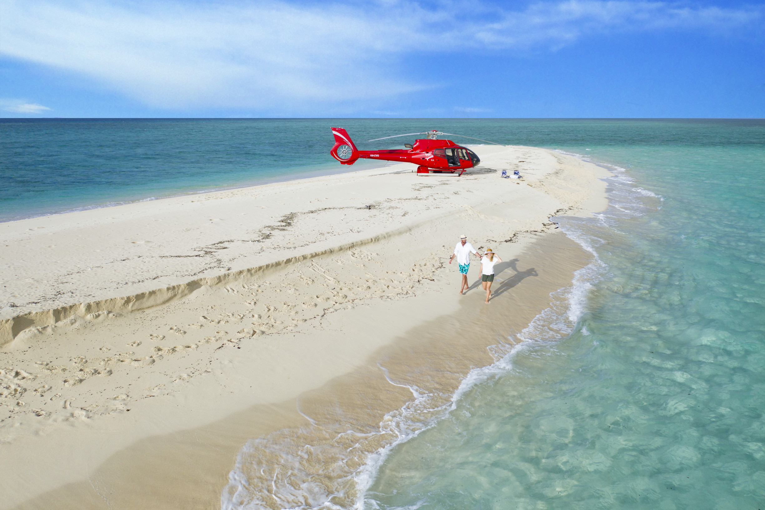 couple walking on sand cay with Nautilus Aviation | best things to do Cairns first timers couple walking on sand cay with Nautilus Aviation | best things to do Cairns first timers