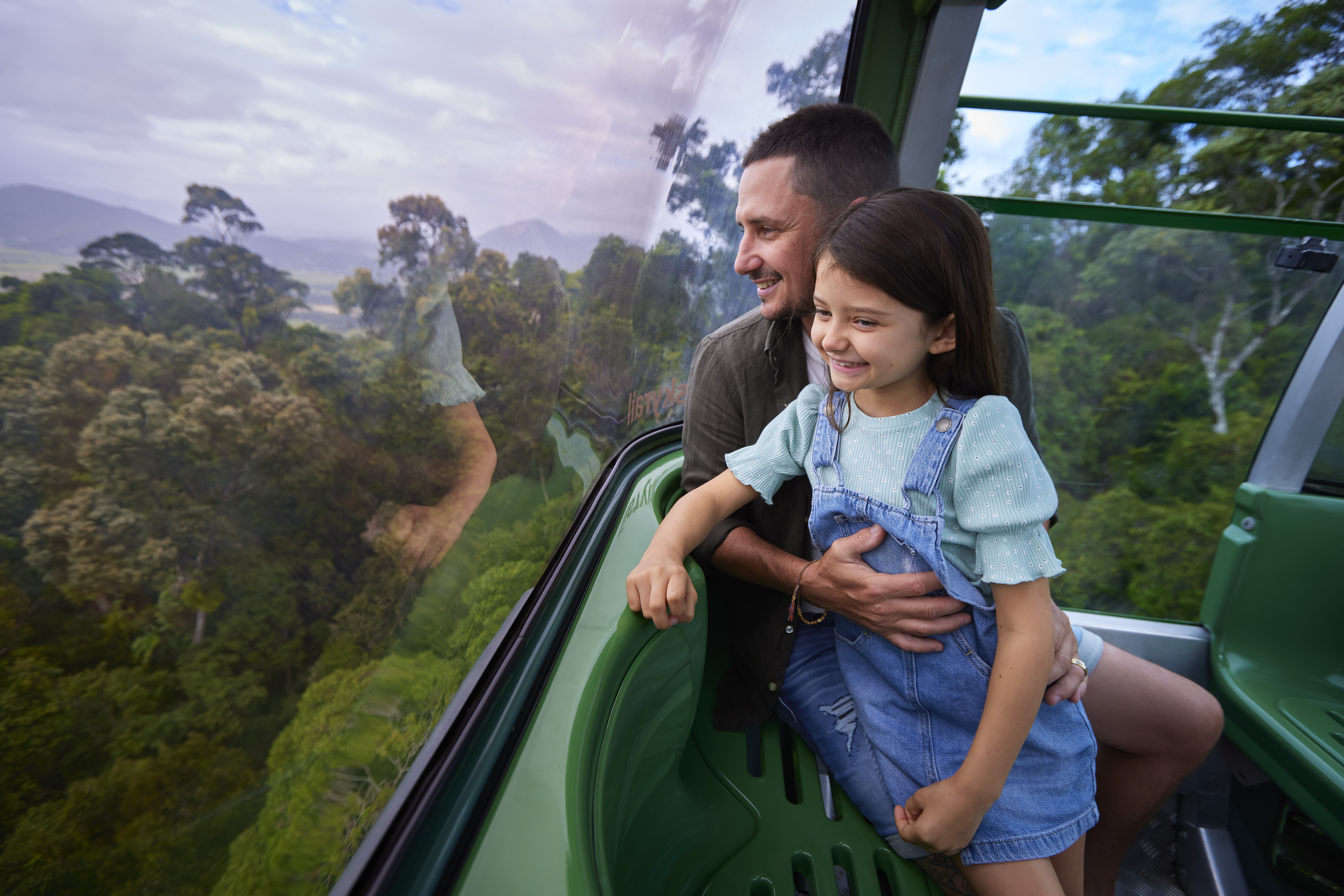 Family travelling on the Skyrail gondola, part of a Tropic Wings day tour | things to do school holidays Cairns Great Barrier Reef