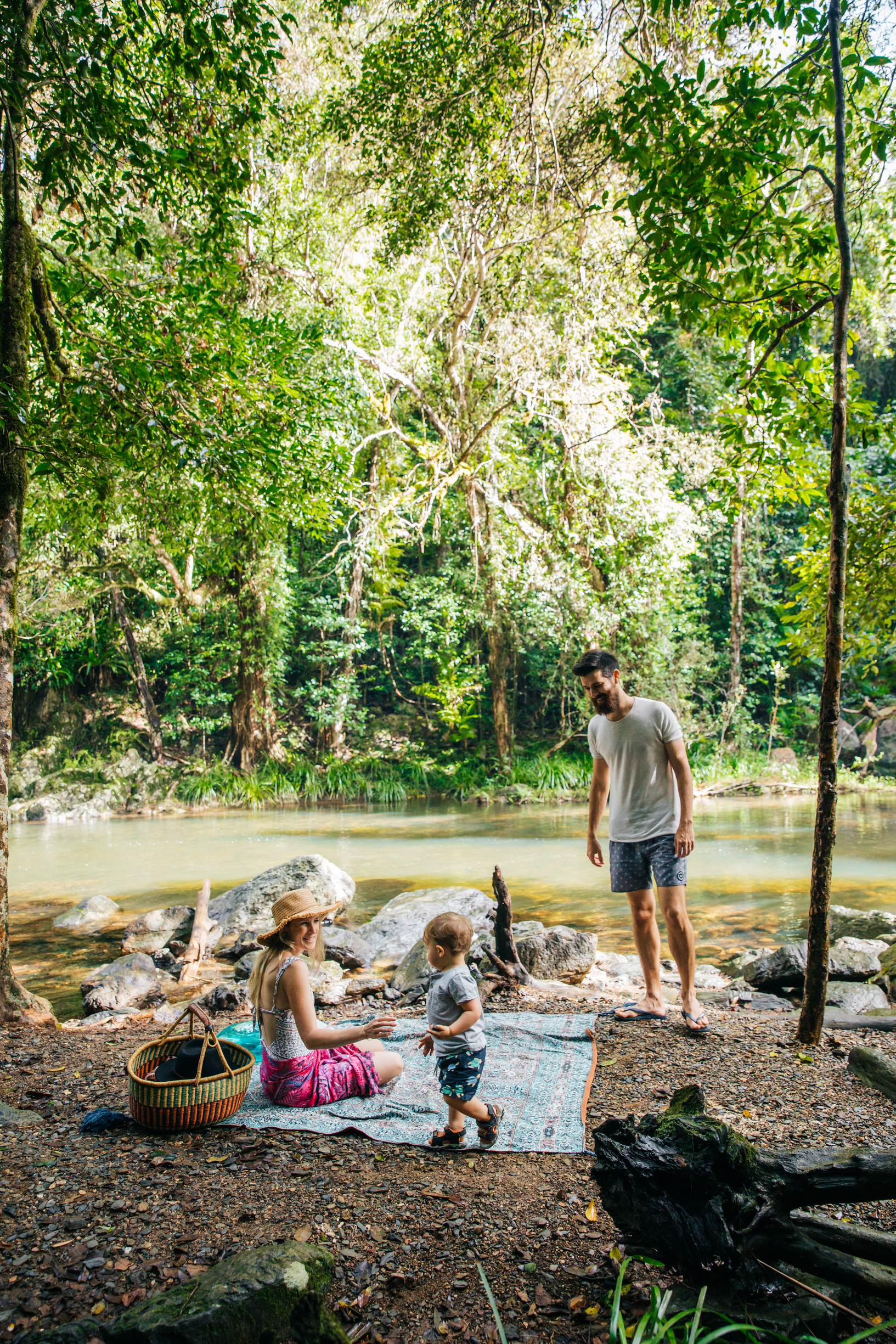 Family with toddler enjoying a picnic at Crystal Cascades near Cairns Family with toddler enjoying a picnic at Crystal Cascades near Cairns