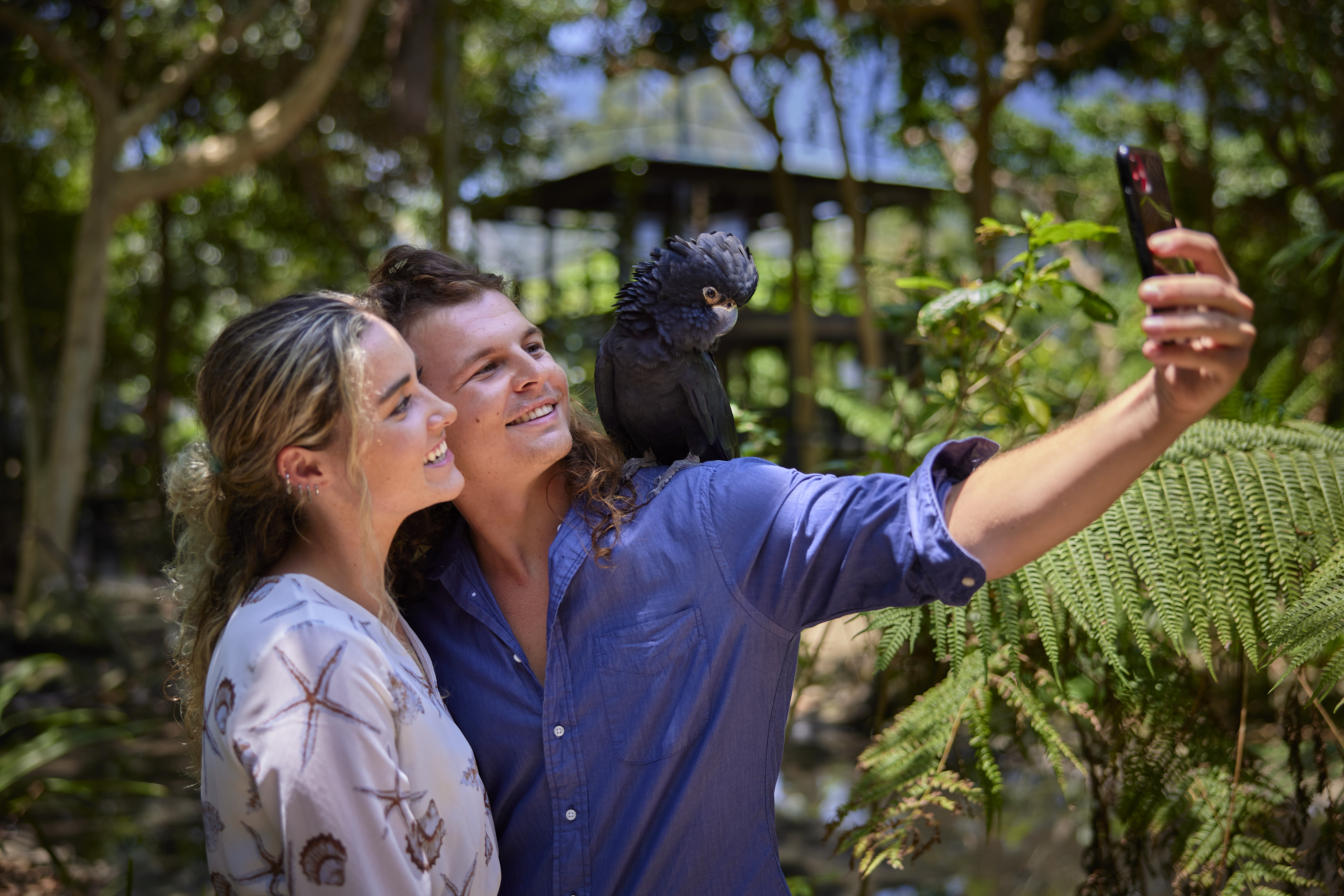 Couple taking a selfie with a cockatoo