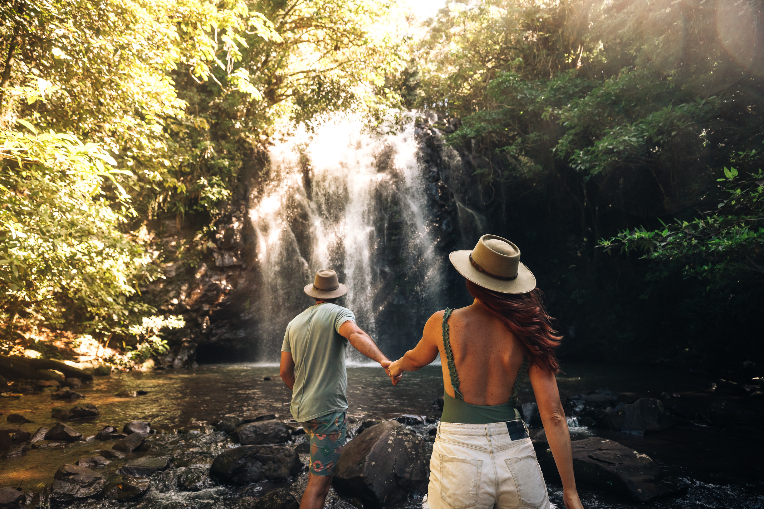 Couple holding hands in front of Ellinjaa Falls