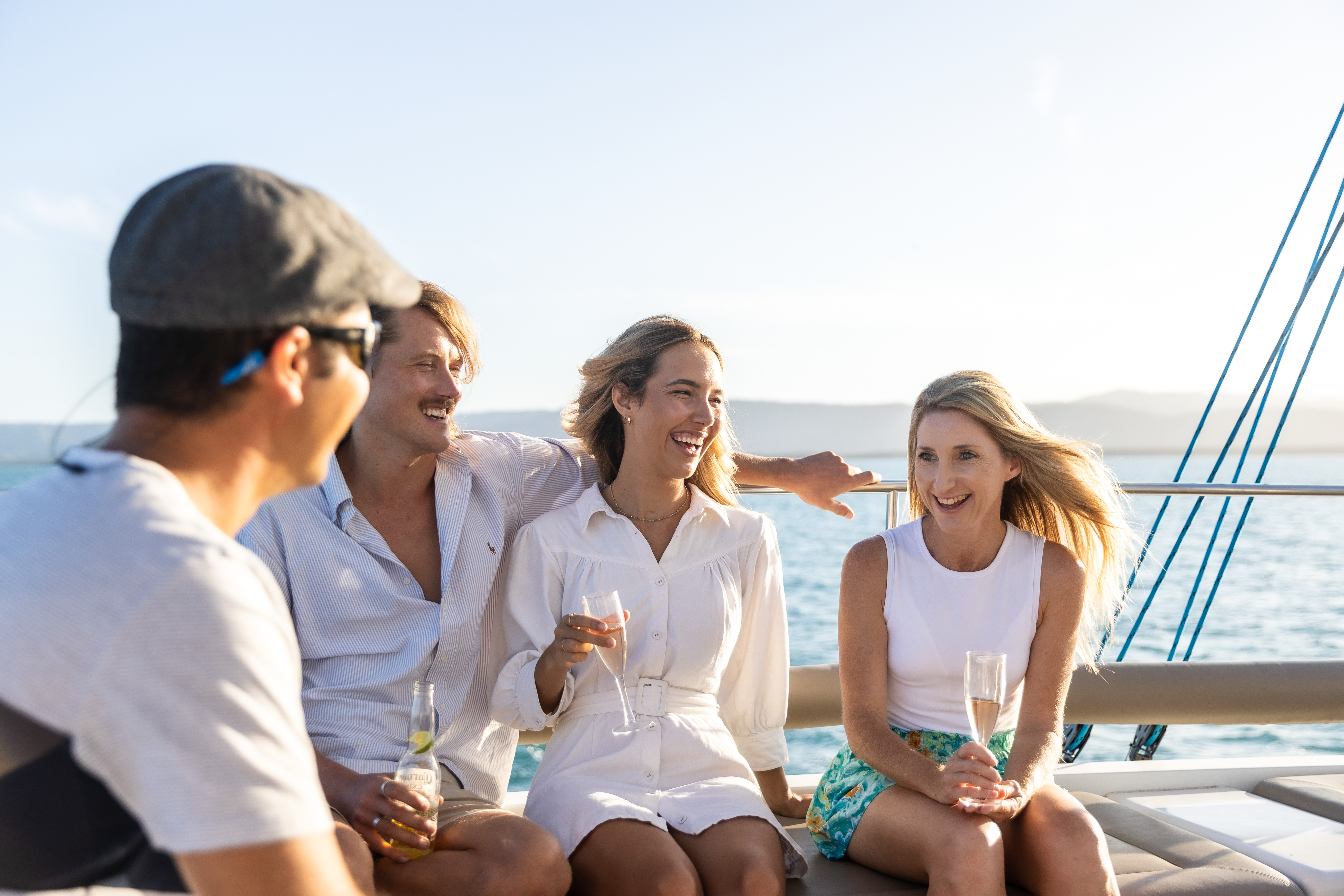 Group of friends having a drink, while relaxing on board Sailaway Reef and Island Tours Group of friends having a drink, while relaxing on board Sailaway Reef and Island Tours