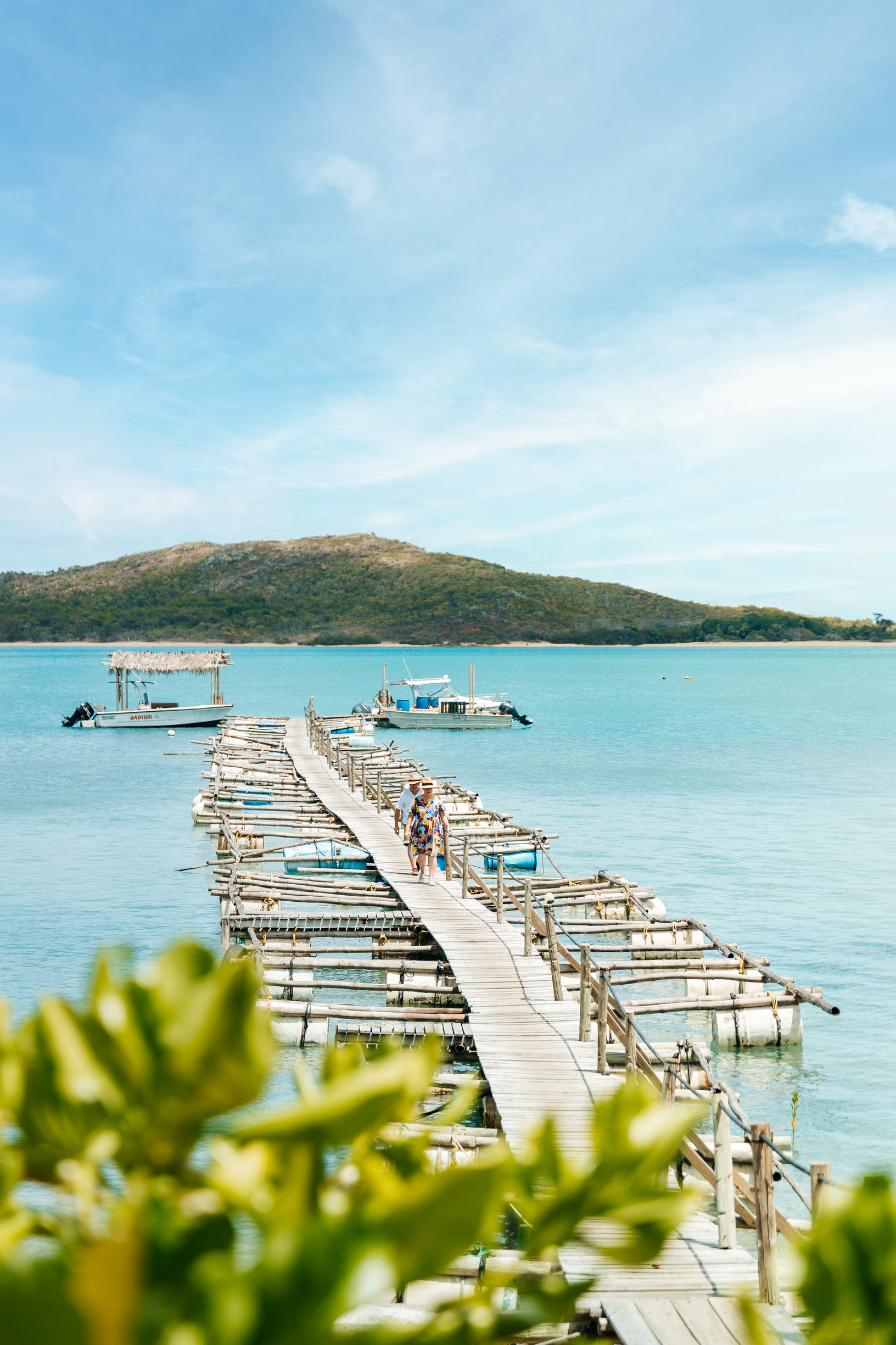 Couple walking down the jetty at Roko Island Torres Strait | things to do couples queensland Couple walking down the jetty at Roko Island Torres Strait | things to do couples queensland