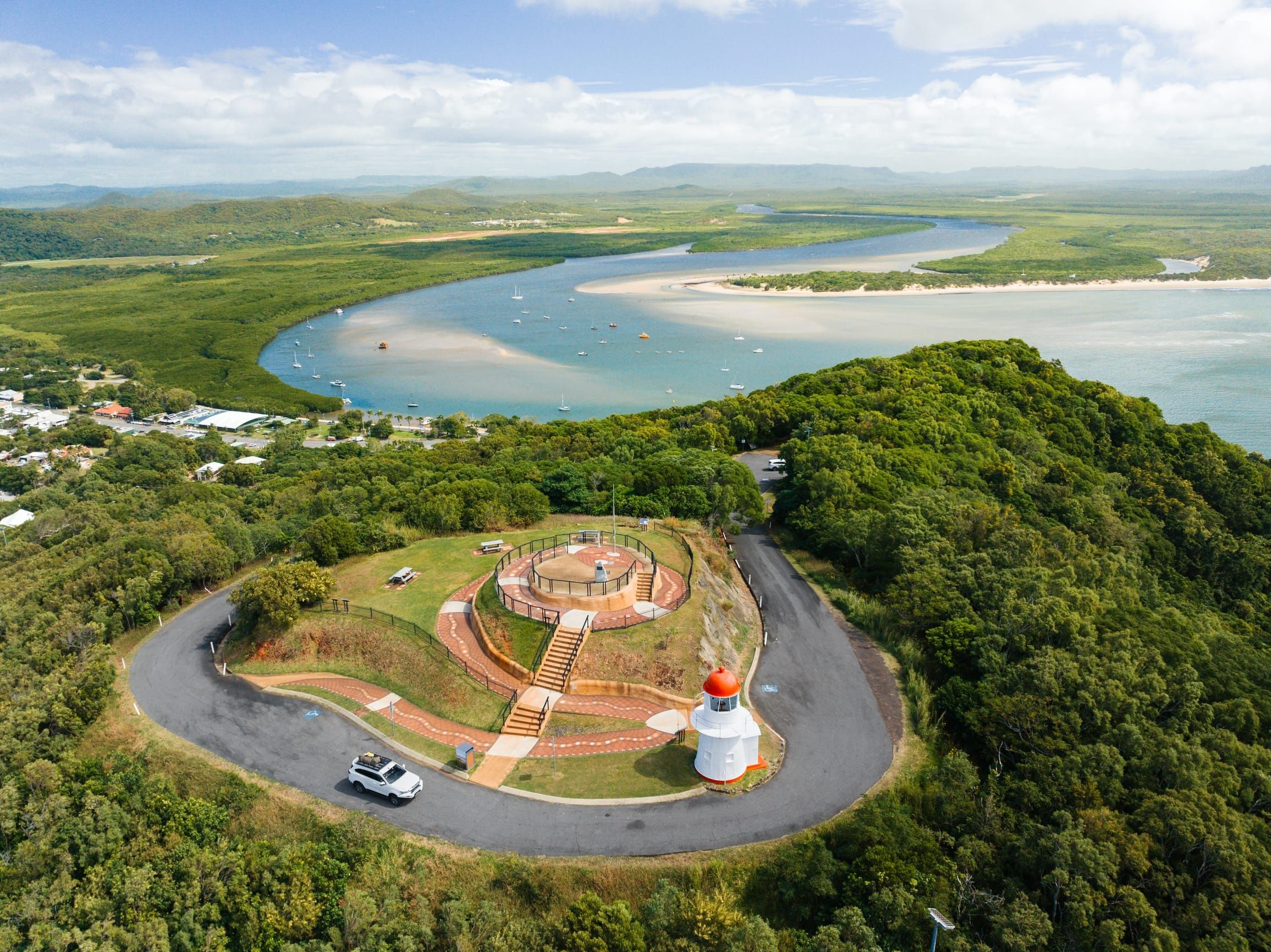 Aerial view of Grassy Hill Lookout with historical lighthouse offering a 360 degree view of Cooktown, the Endeavour River and the Great Barrier Reef.