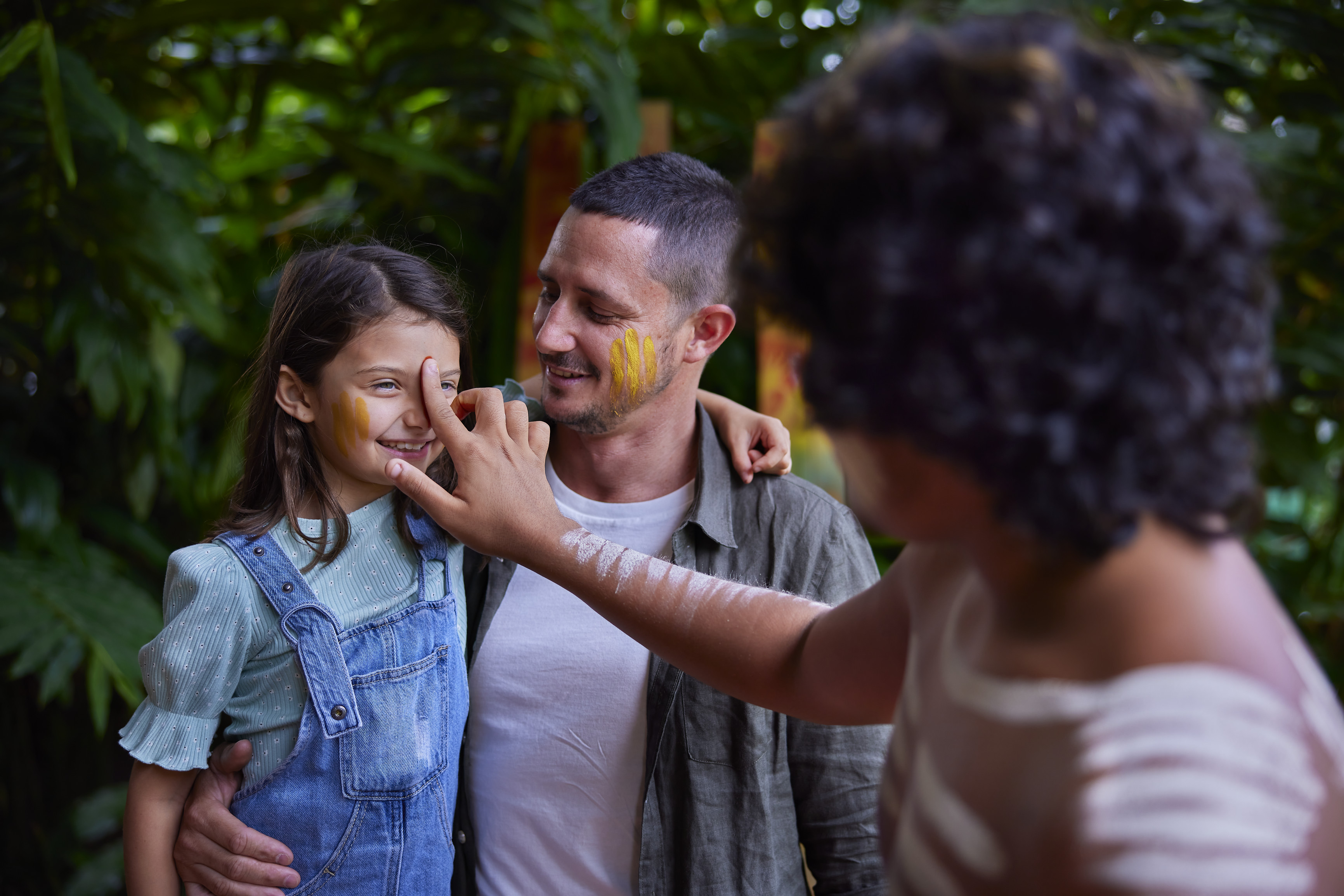 Young girl having her face painted by an Aboriginak man at Pamagirri Aboriginal Experience at Rainforestation Nature Park