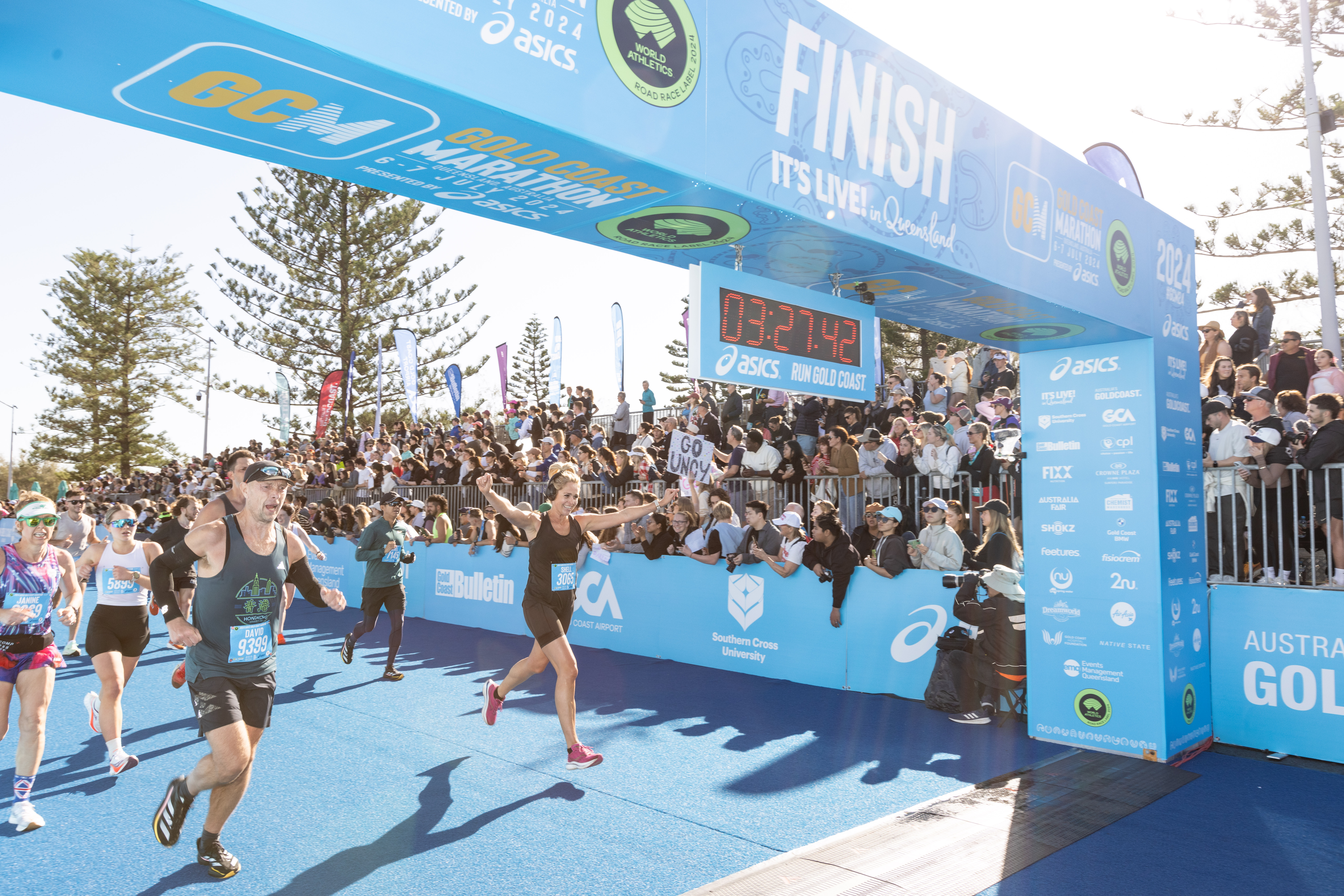 A runner running over a finish line at a marathon A runner running over a finish line at a marathon
