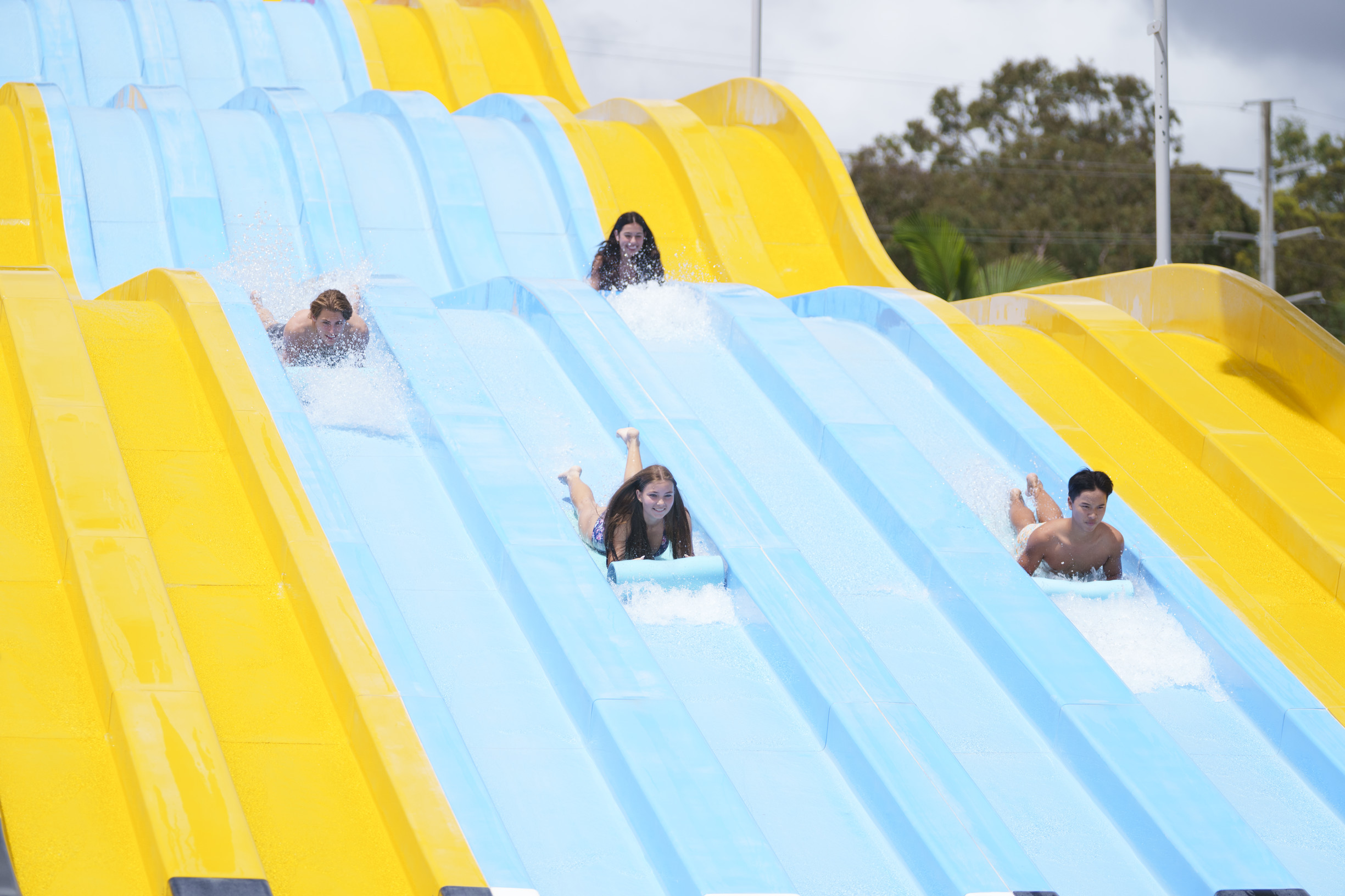 Friends race down multi lane waterslide at Wet n Wild