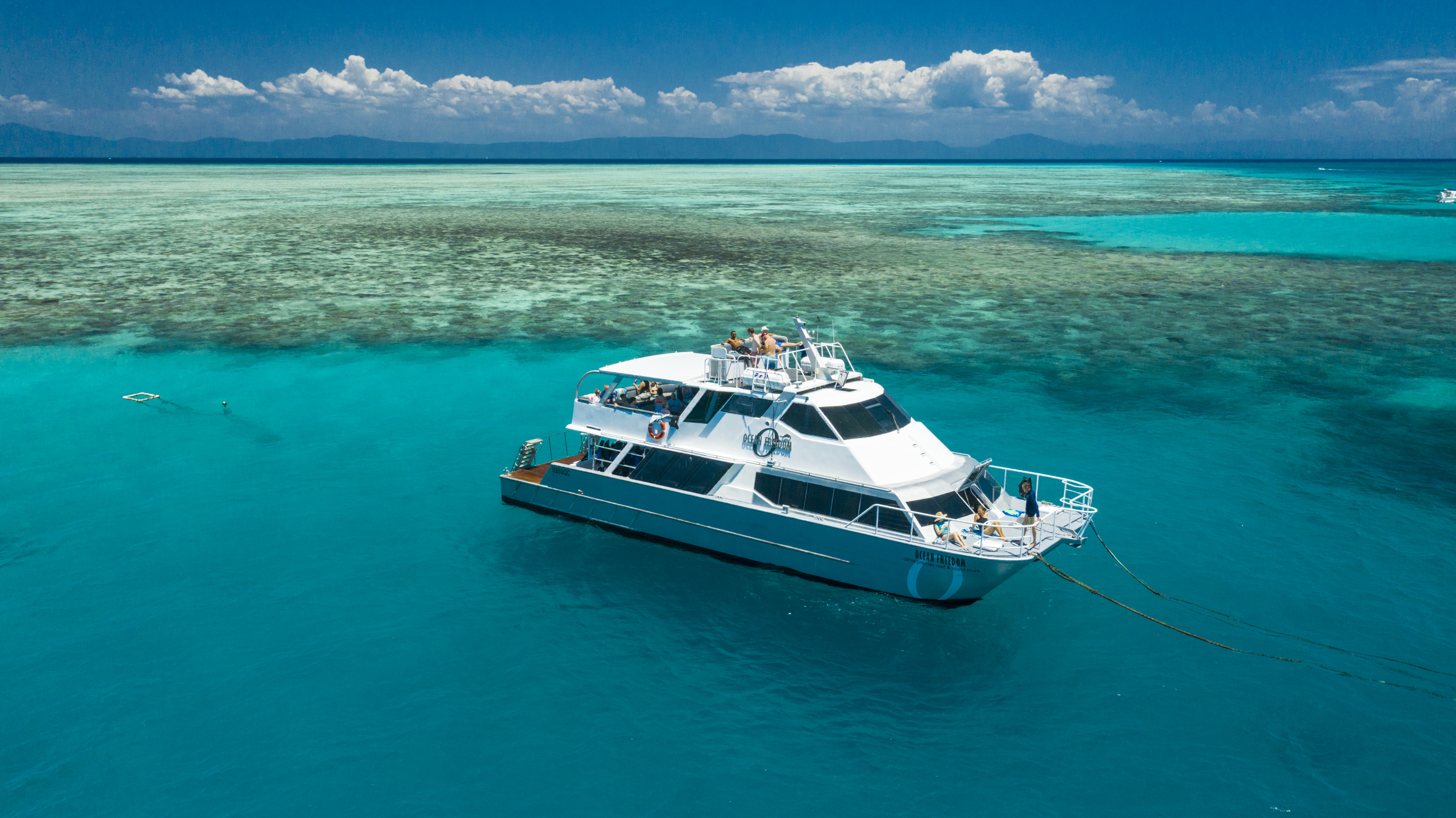 Aerial view of guests relaxing on the Ocean Freedom boat moored at Upolu Reef Aerial view of guests relaxing on the Ocean Freedom boat moored at Upolu Reef