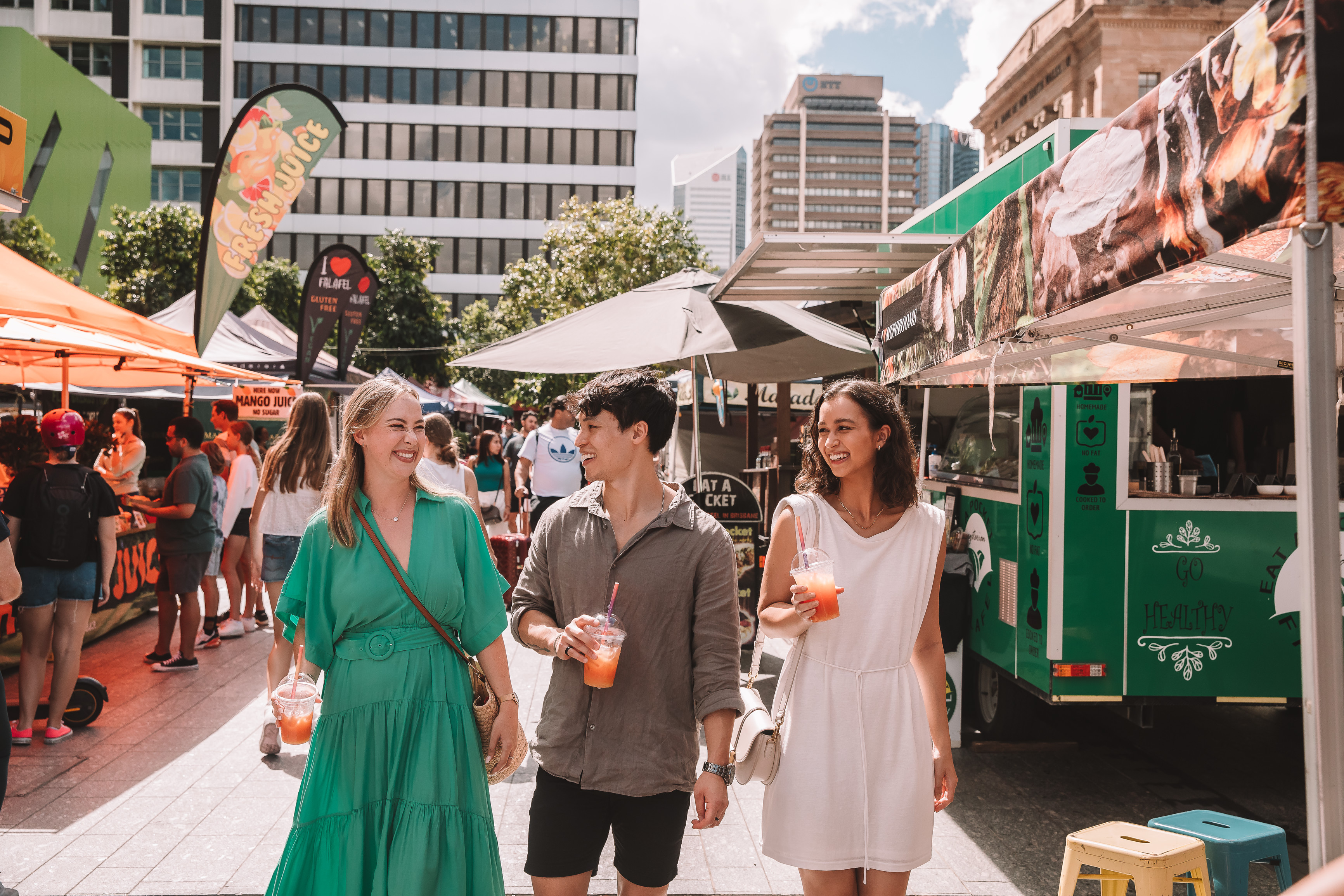 Group of friends walking through the Brisbane City Markets Group of friends walking through the Brisbane City Markets