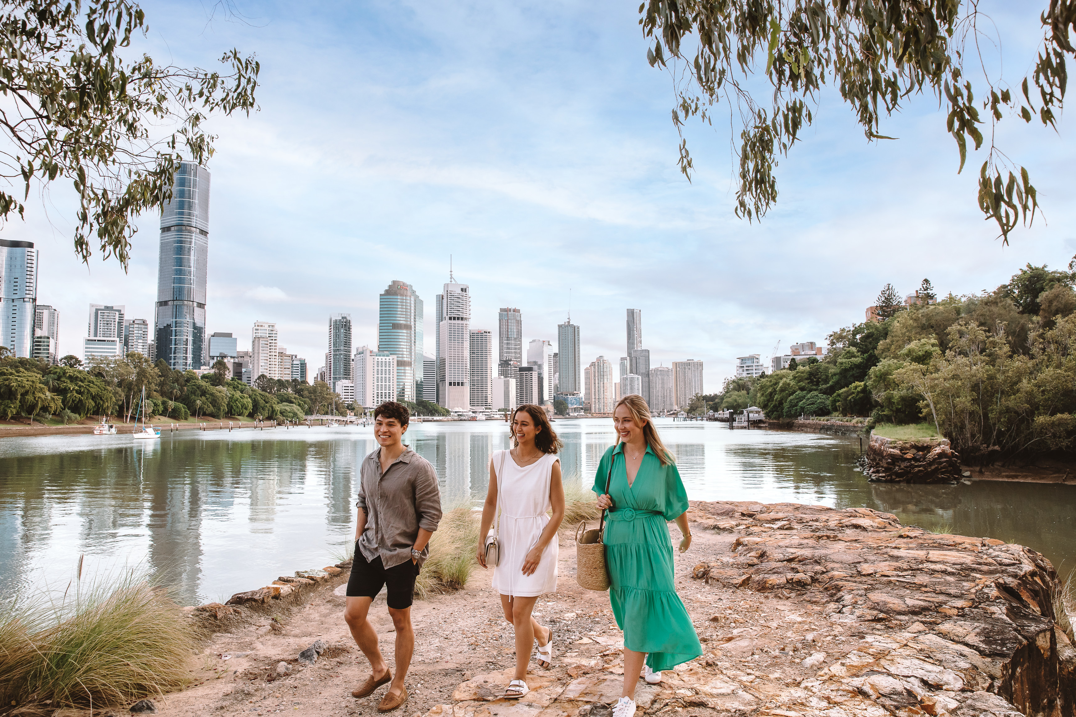 Group of friends walking along the Brisbane Riverwalk Group of friends walking along the Brisbane Riverwalk