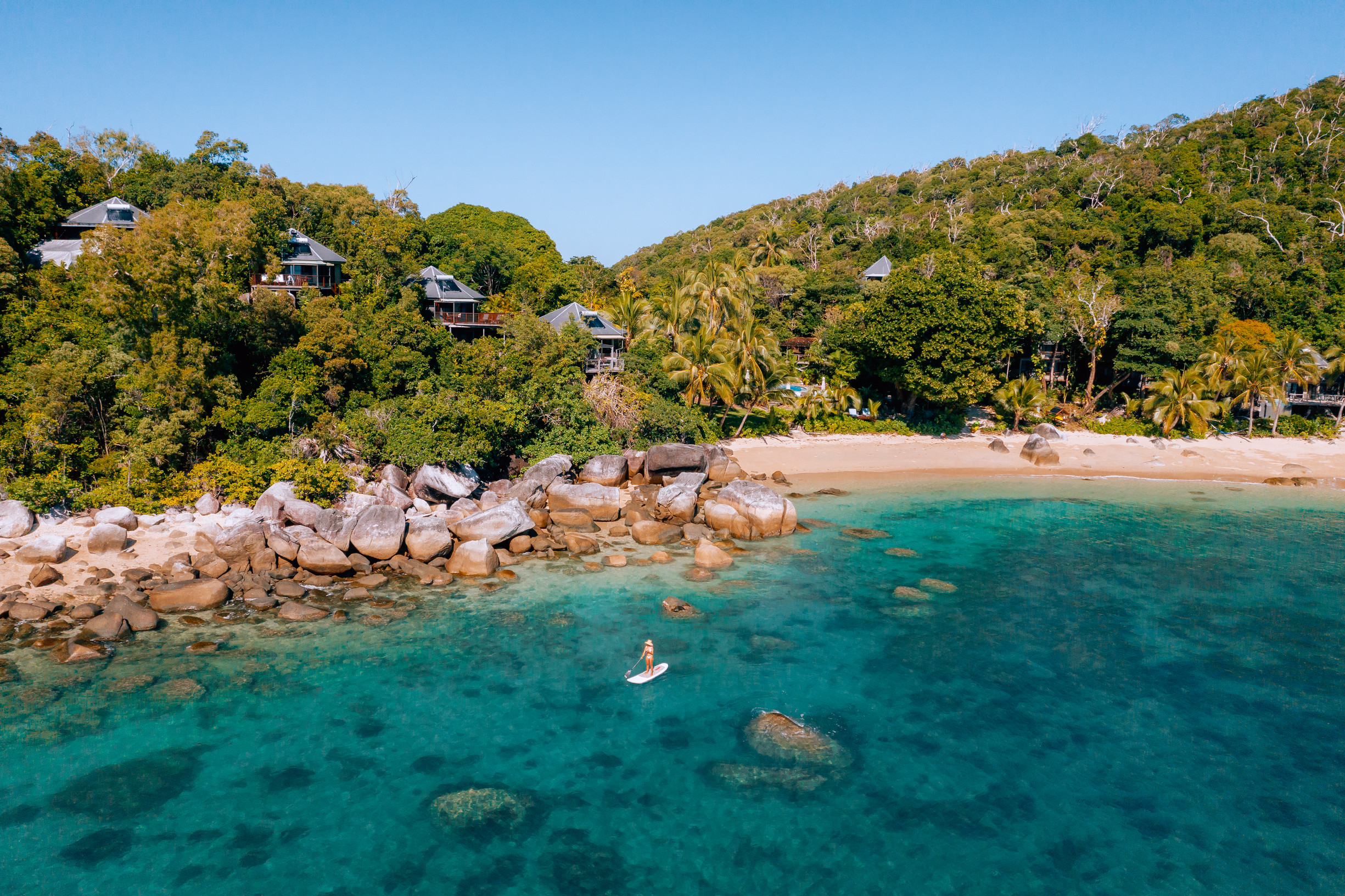 Guest stand-up paddle boarding at Bedarra Island Resort Guest stand-up paddle boarding at Bedarra Island Resort