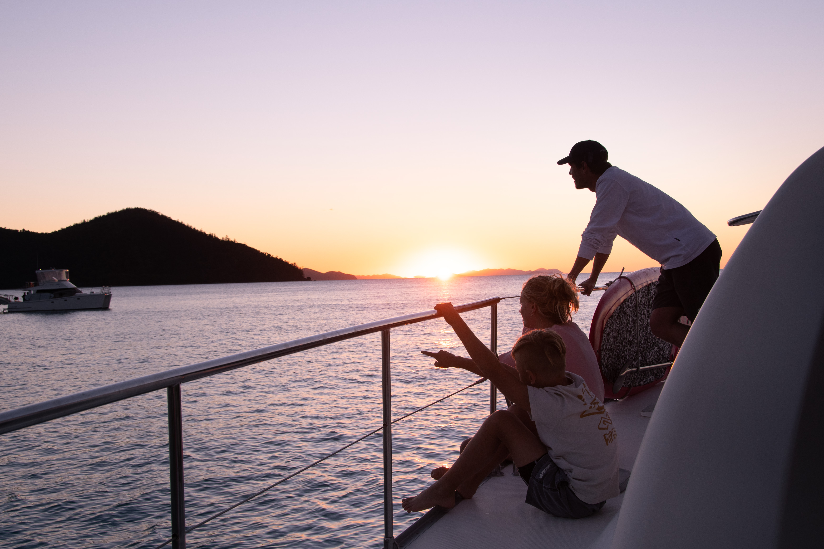 Family enjoying the sunset on board a bareboat charter | family sailing holiday whitsundays Family enjoying the sunset on board a bareboat charter | family sailing holiday whitsundays