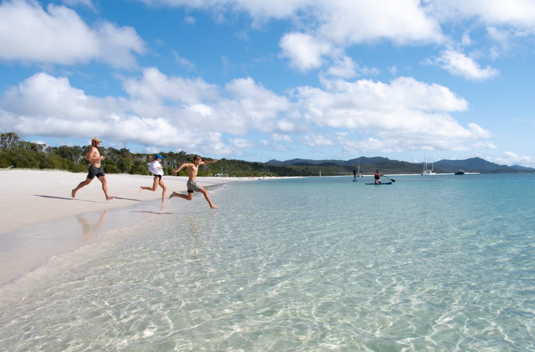 A family having fun on Whitehaven Beach A family having fun on Whitehaven Beach
