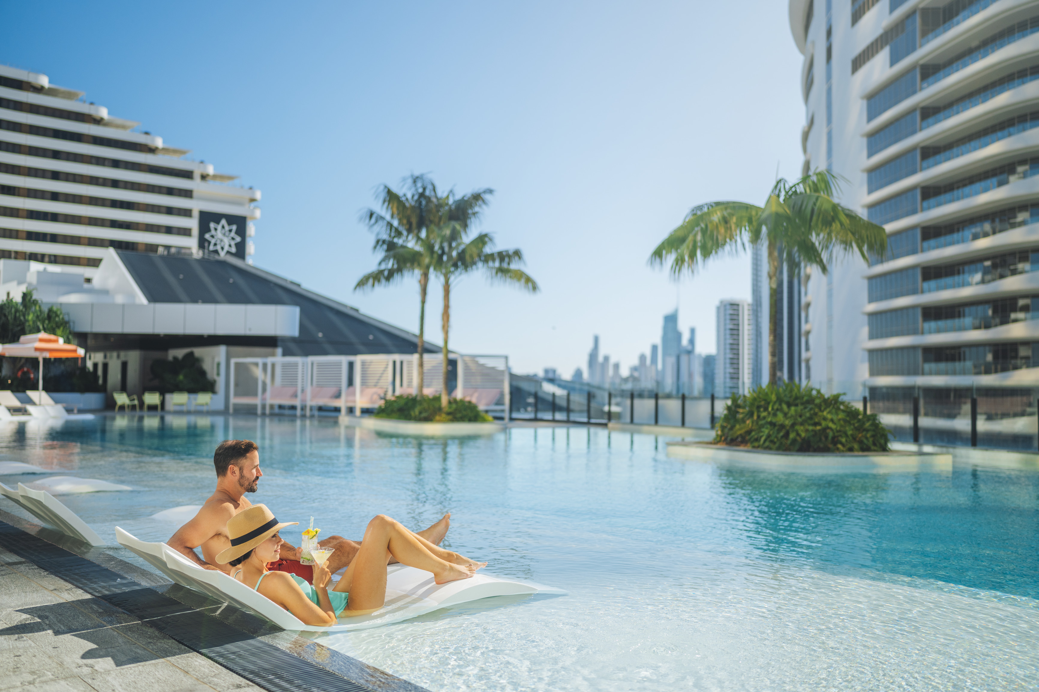 Couple relaxing at the Isoletto Pool Club at the Dorsett Gold Coast Couple relaxing at the Isoletto Pool Club at the Dorsett Gold Coast