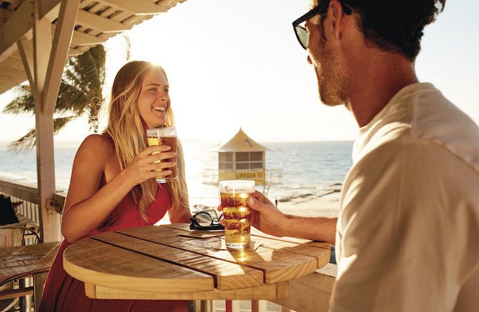 Two people enjoying a drink at the Rainbow Bay Surf Club Two people enjoying a drink at the Rainbow Bay Surf Club